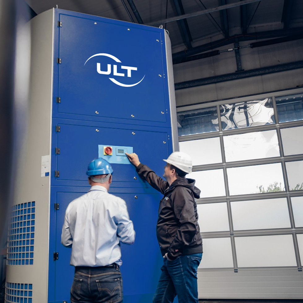 Two men in front of the blue system