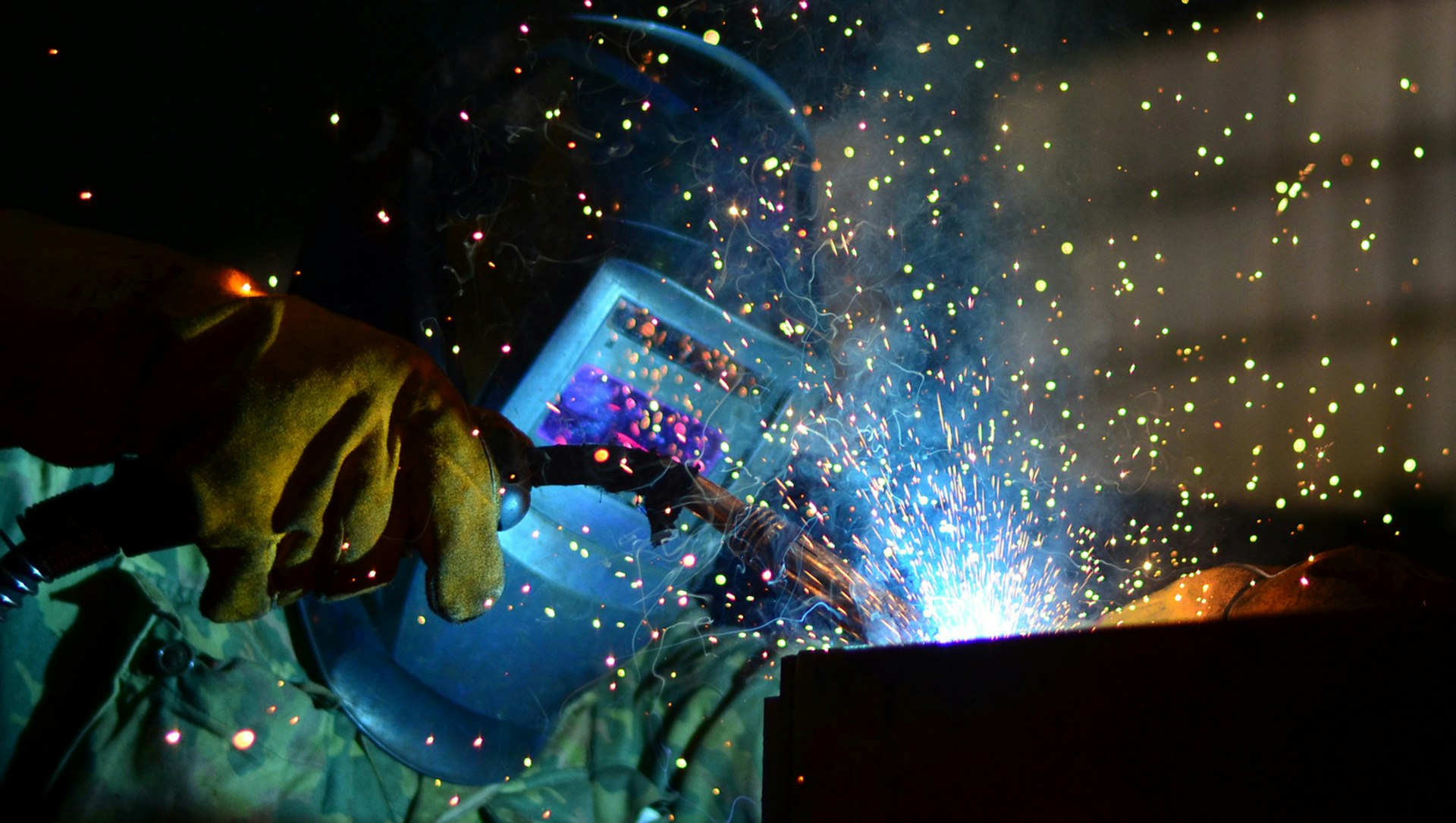Welder does his job, sparks are flying
